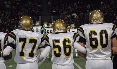 Image: Brandon Connor(77), John Escamilla(56) and Kevin Roldan(60) display unity during the coin toss.