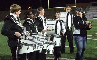Image: The drumline is having fun as Reagan Adams, on the cymbals, keeps the group smiling.