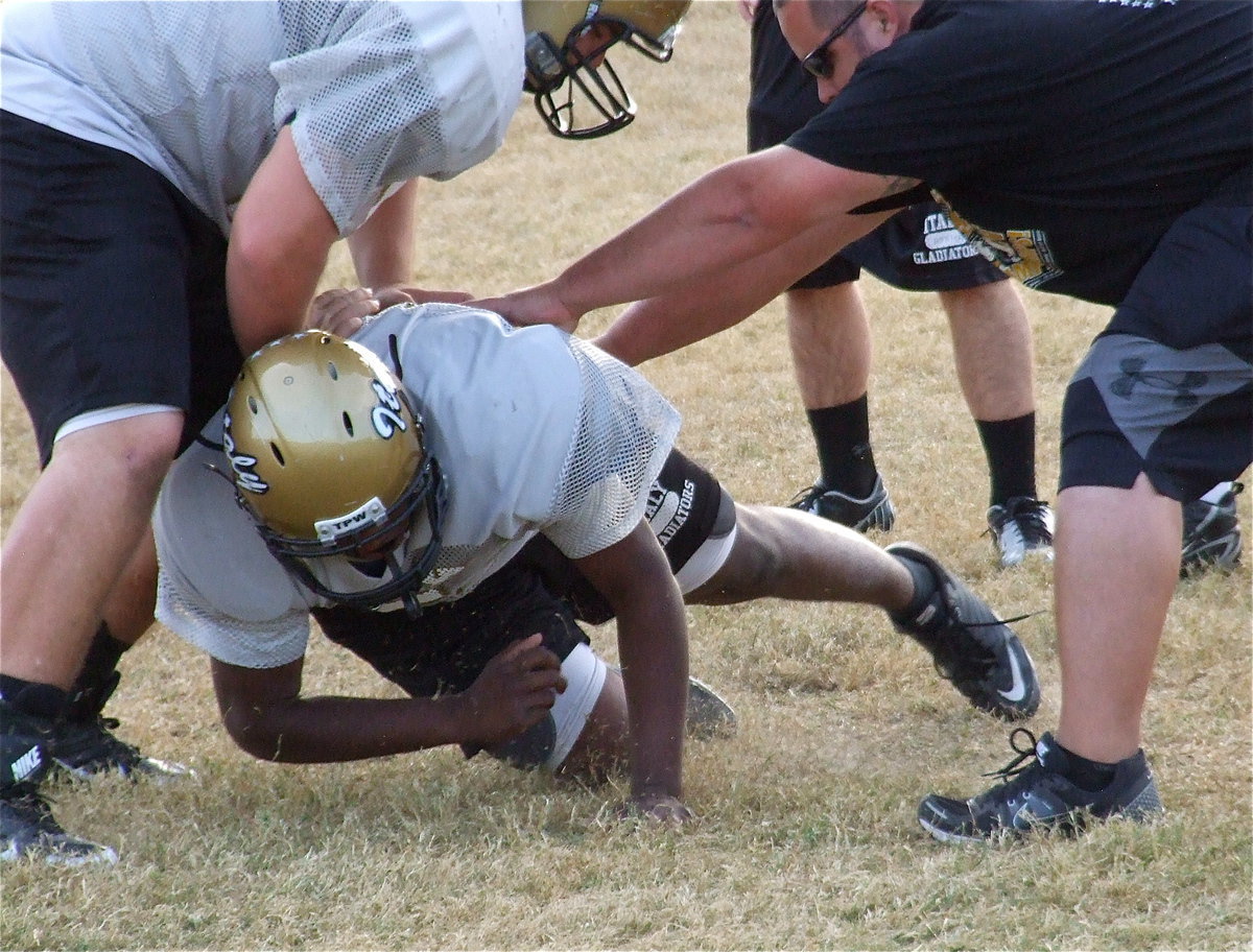 Image: Justin Robbins takes on Kevin Roldan and Coach Brandon Duncan for gap control.