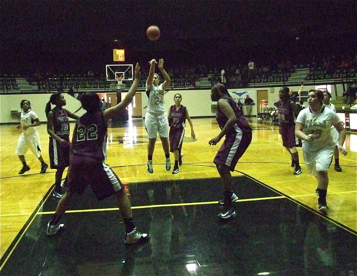 Image: Alyssa Richards(24) takes a shot from the top of the lane against Faith Family as Monserrat Figueroa(25) crashes the board.