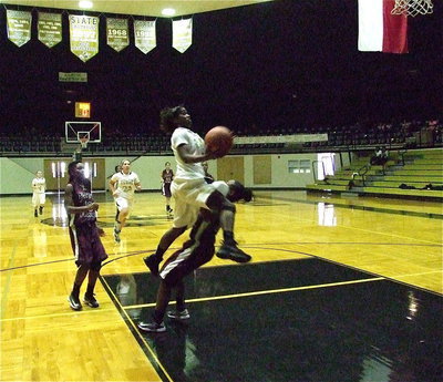Image: “KJ3” tries to clear a defender on the way to the basket.