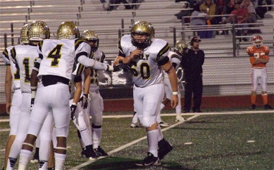 Image: Junior kicker Kevin Roldan(60) commands his special team’s unit before teeing off against Honey Grove.