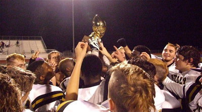 Image: The Italy Gladiators are presented the 2012 Class A Regional Semifinal Championship trophy and then celebrate by raising the trophy high.