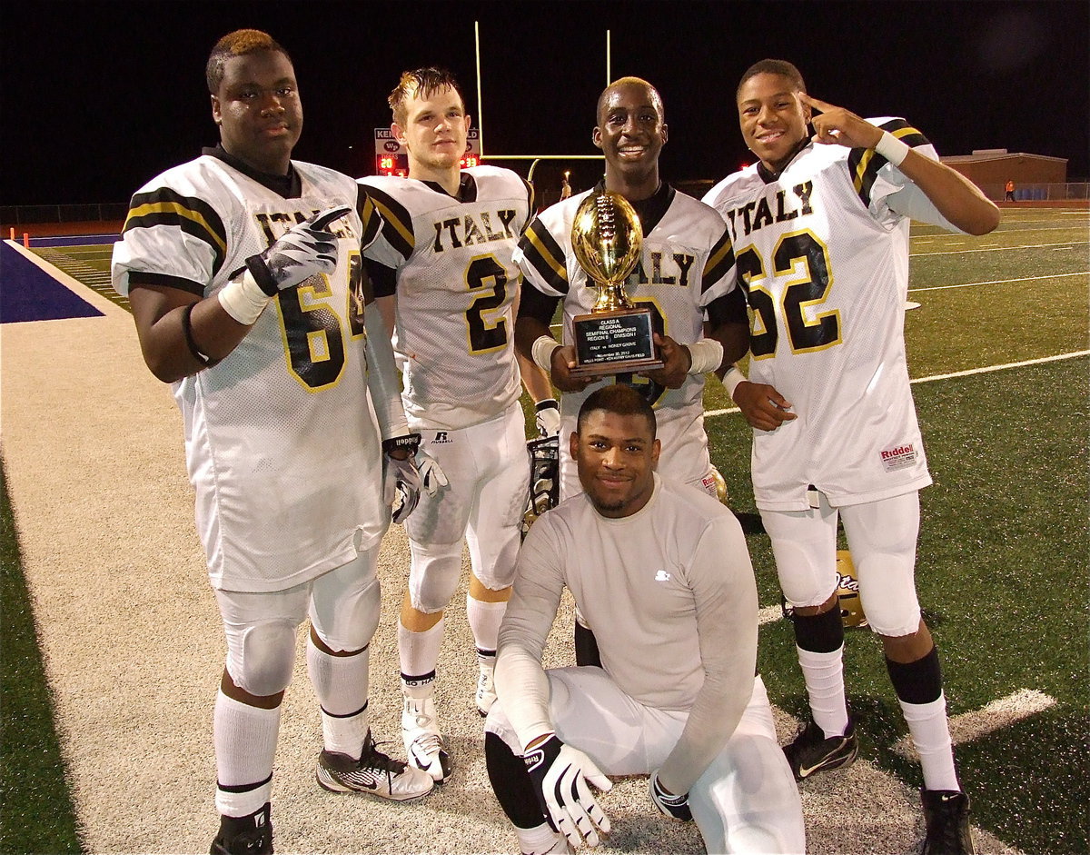 Image: A handful of Gladiator seniors including Adrian “BoBo” Reed(64), Chase “Ham-bone” Hamilton(2), Marvin “MC3” Cox(3), Jalarnce Jamal “Shorty” Lewis(21) and John “Squirt” Hughes(62) celebrate with the regional semifinal championship trophy.