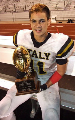Image: Senior tackle Reid Jacinto(11) sits for a moment with the regional semifinal championship trophy.