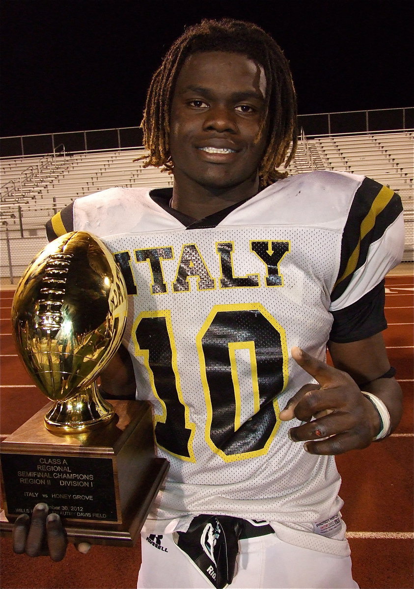 Image: Ryheem Walker(10) proudly holds the regional championship trophy that he helped win. Walker rushed for 200 yards on 22 carries, scored one touchdown and posted 9 tackles on defense with 7 solo tackles including a quarterback hurry.