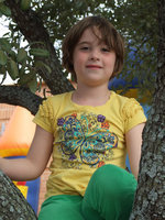 Image: Kathryn Dabney, age 5, enjoys climbing a nearby tree during the Thanksgiving feast.