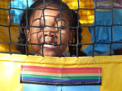 Image: Jalecia, age 6, takes a moment to take a picture in the bounce house.