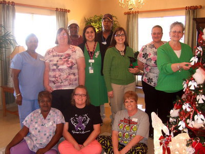 Image: Trinity Mission staff: Georgia Stanford, Emily Finley, Dodie Chambers, Mary Copeland, Carolyn Powell, Amanda Wilsford, Darla Gardner, Lisa Marie (therapy dog), Michelle Ross, Paul Sanderford and Johnny Walker.