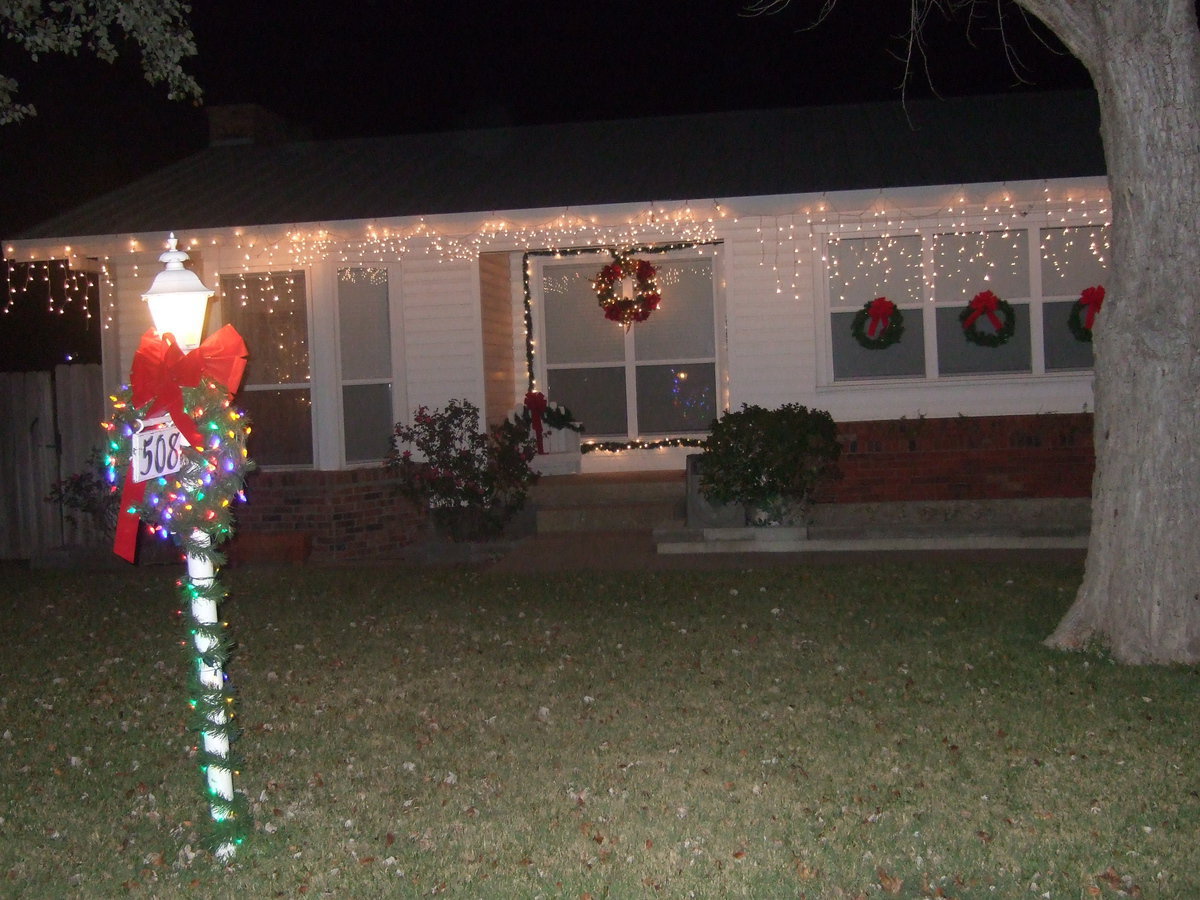 Image: Christmas lights and wreaths say Merry Christmas.