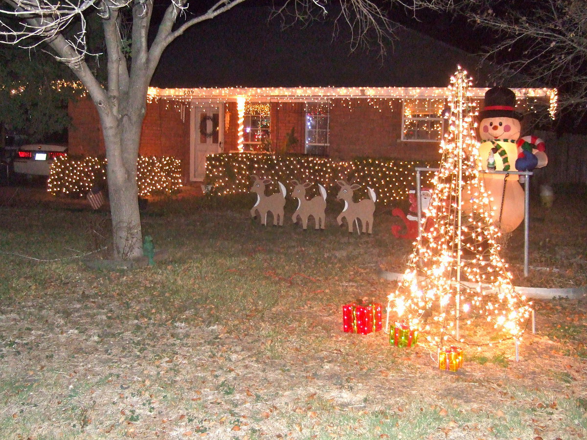 Image: Reindeer, Frosty and a Christmas tree all say Merry Christmas.