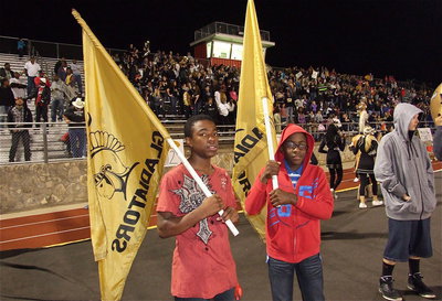 Image: Kendrick Norwood and Michael Wilson, members of the Italy JH Gladiators, help inspire the varsity squad by keeping the school’s flags waving.