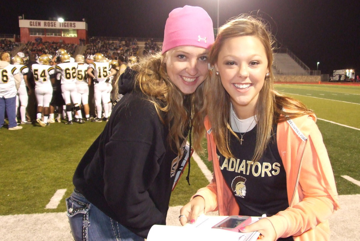 Image: Stat squad members Jaclynn Lewis and Bailey Eubank make the most of a break in the action.