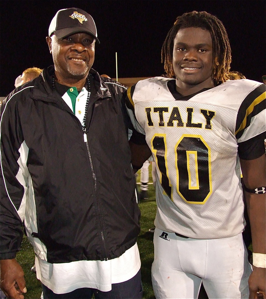 Image: Gladiator Fan of the Year, Billy Ray Turner, congratulates Ryheem Walker(10) and the Gladiators on winning the quarterfinal championship over Goldthwaite.