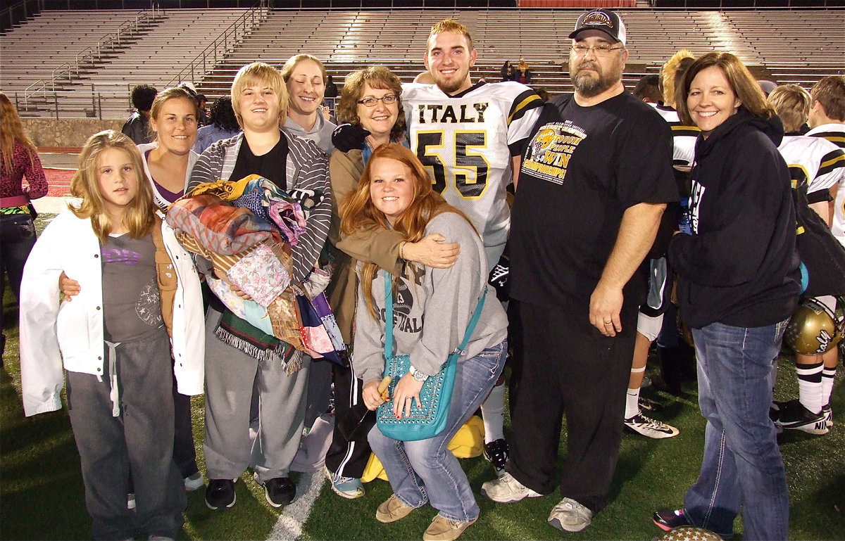 Image: Senior Gladiator Zackery Boykin(55) stands proud with his love ones after Italy disposes of the Goldthwaite Eagles in Glen Rose.