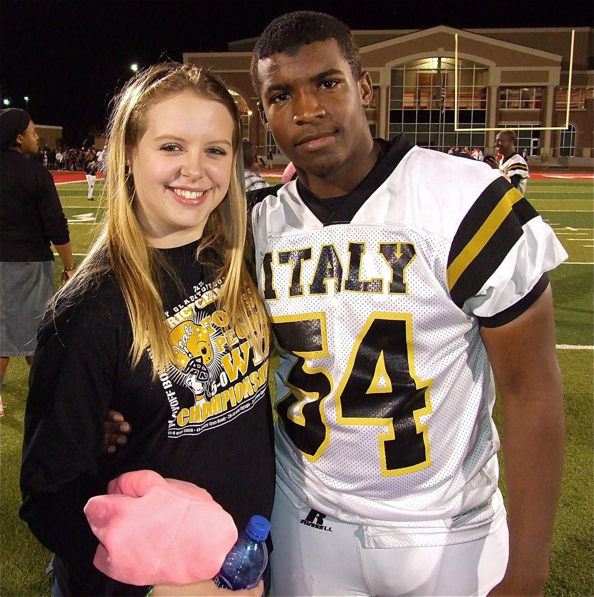 Image: Tia Russell congratulates Justin Robbins(54) after Italy’s playoff win over Goldthwaite.