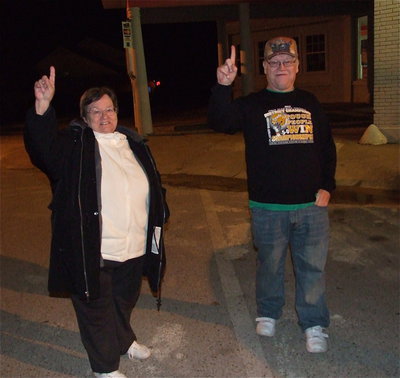 Image: Holly and James Spraberry are excited as the Gladiator team busses make their way thru downtown Italy after returning from their quarterfinal championship win over Goldthwaite.