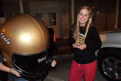 Image: Tatum Adams, under the helmet, and Madison Washington participate in the downtown celebration.
