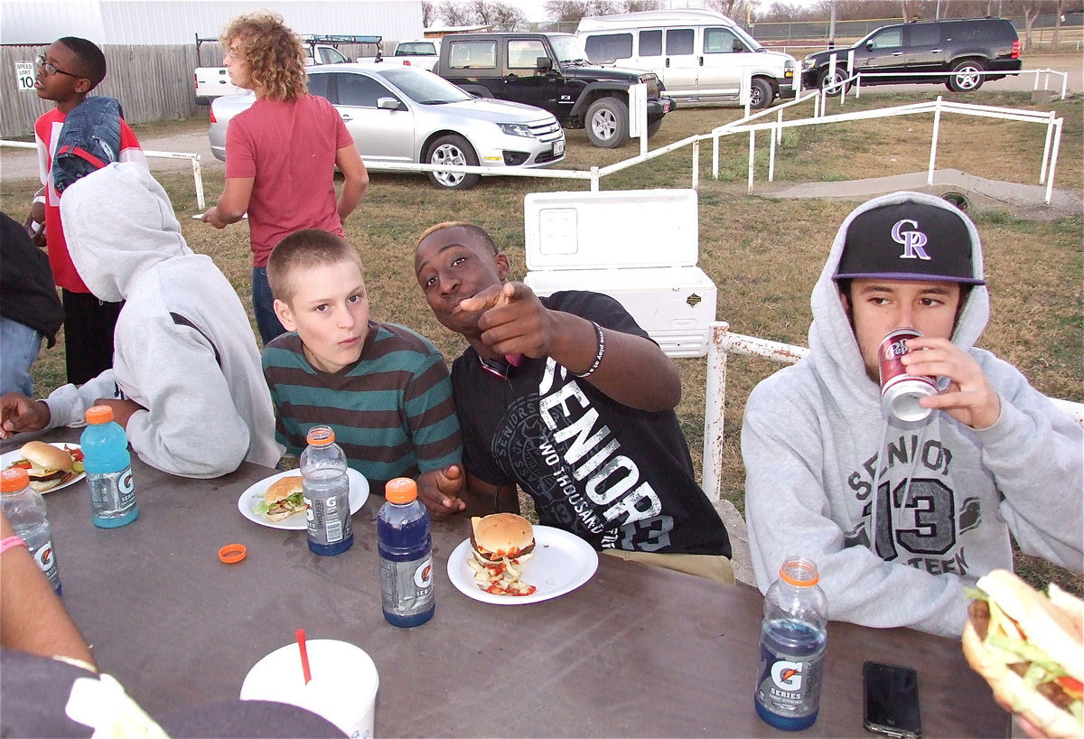 Image: Team manager Clay Riddle, Marvin Cox and Caden Jacinto are just enjoying the moments leading up to game time.