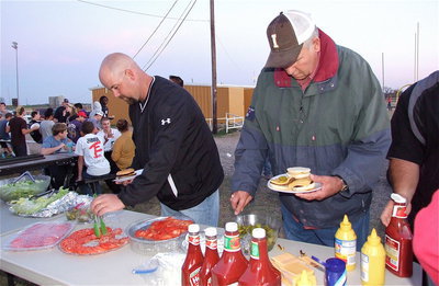 Image: Italy’s HFC/AD Hank Hollywood and Gladiator backer Richard Cook dig right in during the cookout.