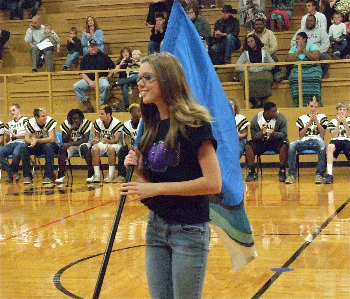 Image: Color guard member Anna Riddle performs for Gladiator fans during the pep rally leading up to the Goldthwaite game.