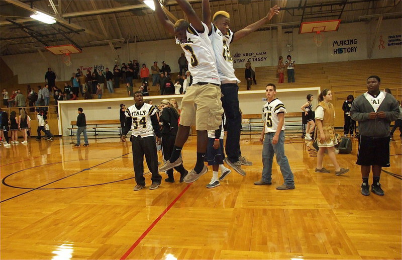 Image: Gladiators Marvin Cox(3) and Eric Carson(12) leap for joy after the pep rally.