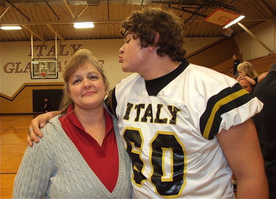 Image: Proud mom, Flossie Galvan, puts up with her lovable but annoying son, Kevin Roldan(60), a junior, who is now Flossie’s third son to play football for Italy.