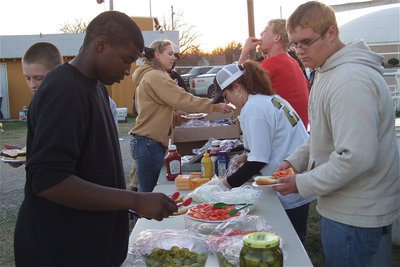 Image: Prior to the pep rally, Justin Robins, Clay Riddle, Jaclynn Lewis, Cody Boyd and Colin Newman enjoy hamburgers as Clover Stiles (in the cap) serves up some team spirit.