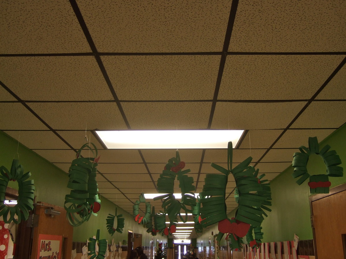 Image: Beautiful wreaths with red ribbons brighten this hall way.