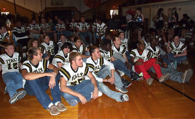 Image: The Gladiators gather around to watch a slideshow, courtesy of Italy Neotribune, displaying images from their most recent games.