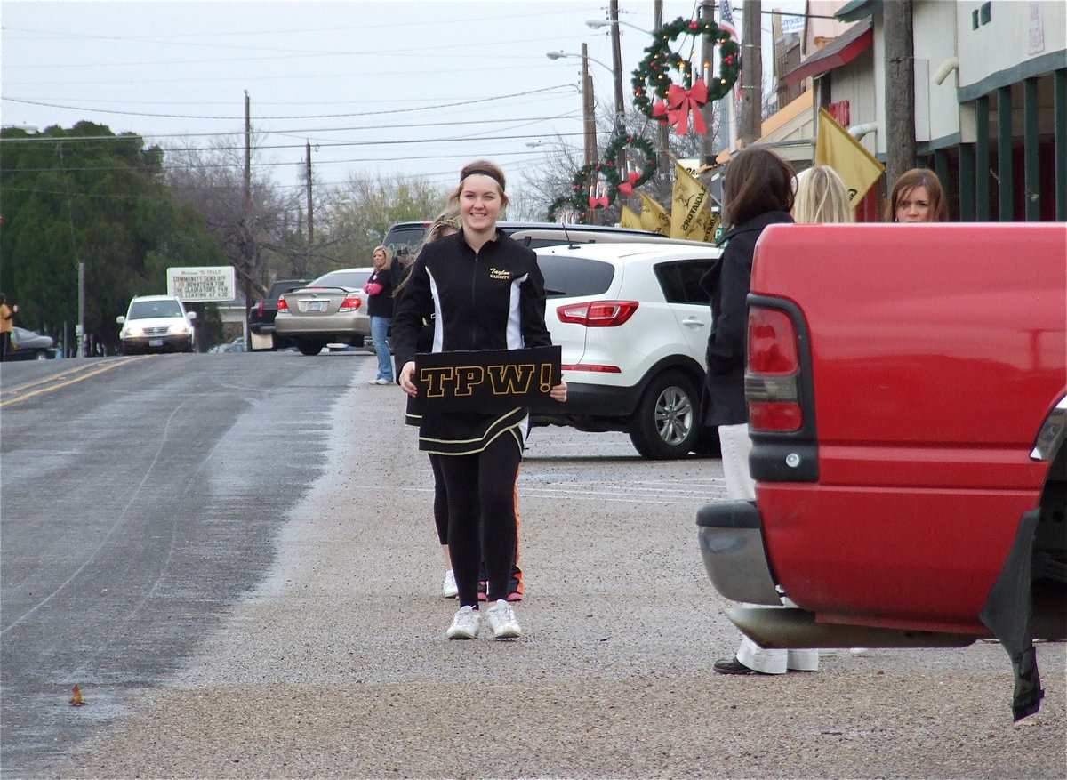 Image: Cheerleader Taylor Turner displays a TPW sign which stands for “Tough People Win” with the Gladiators showing plenty of toughness this season.