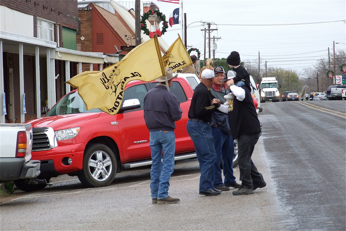 Image: Flags wave as the Gladiator faithful get into position along main street.