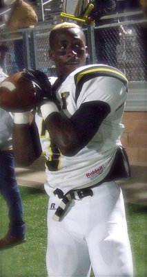 Image: Senior Marvin Cox(3) gets his throwing arm warmed up before the kickoff.