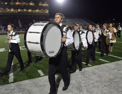 Image: Senior drum line captain Gus Allen leads his crew off the field after a rousing halftime display by the Gladiator Regiment Band.