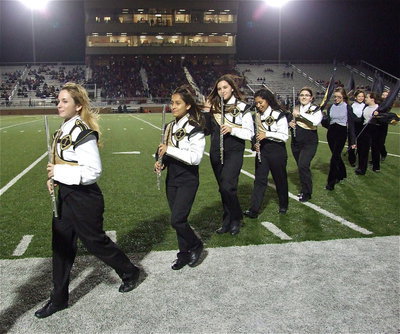 Image: Sarah Levy, Laura Luna, Alexis Sampley, Julissa Hernandez, Morgan Junkin, Anna Riddle, Alexis Burchett and Paige Little exit the field feeling proud of their band’s performance.
