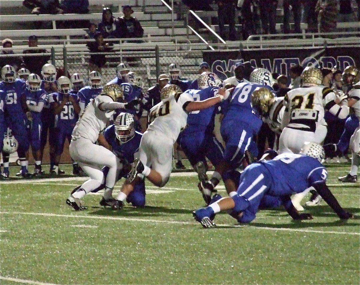 Image: Reid Jacinto(11), Zain Byers(50) and Jalarnce Lewis(21) try to clamp down on a Stamford back.