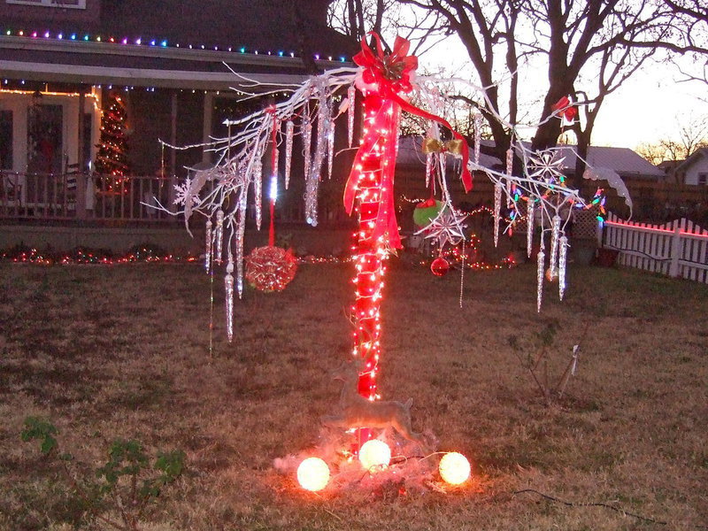 Image: Here is a festive tree made by Gayle Kinsey with a post used in summer for their roses but now it is a  tree with real tree limbs anchored to the post to create this beautiful Christmas tree.