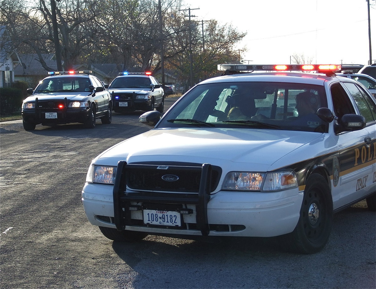 Image: Go, Go, Go! The Italy Police Department exits the Stafford Elementary parking to entourage the six students to Wal-Mart in Waxahachie for a “Shop with a Cop” spree.