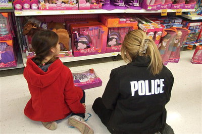 Image: Farrah Eglich and Sergeant Tierra Mooney stay low as to not be detected while shopping for Christmas.