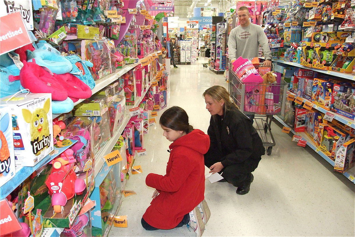 Image: Farrah Eglich, Sergeant Tierra Mooney and Officer Bobby McFarland replace the traditional red and green Christmas with pinks and purples.