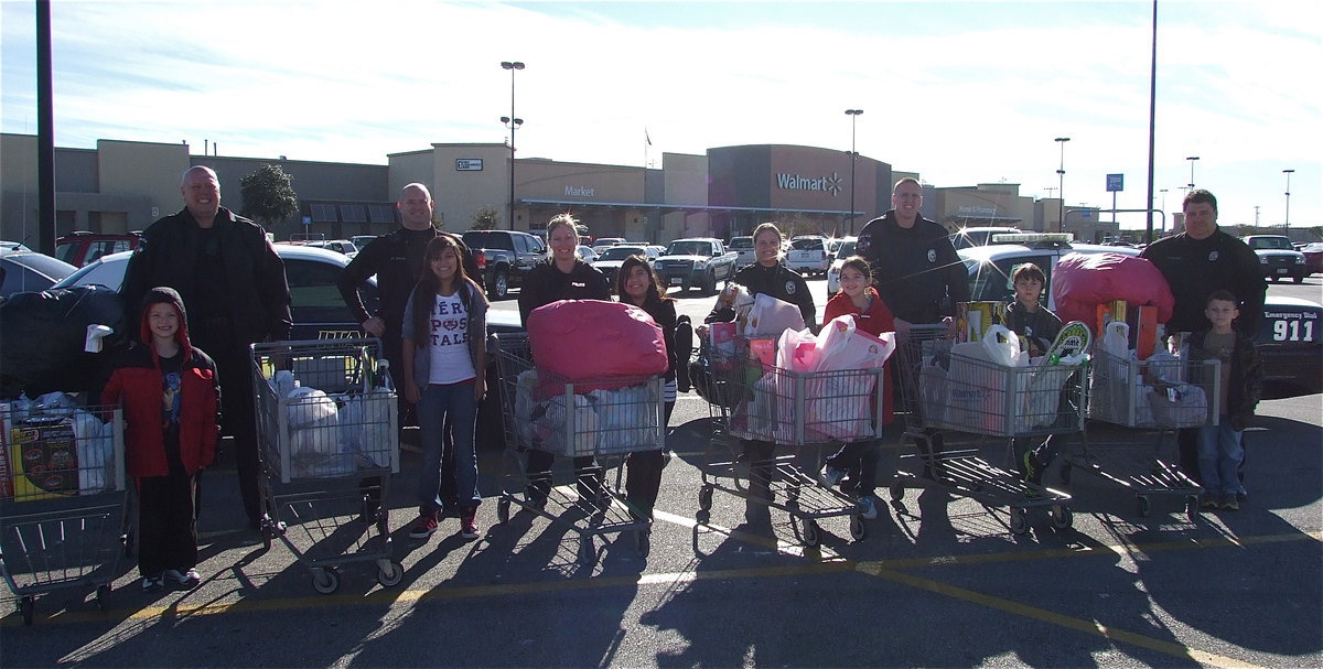 Image: The Italy Police Department poses with, “Santa’s Six,” outside the Wal-Mart in Waxahachie as part of the department’s “Shop with a Cop” program. Pictured (L-R): Christopher Cryer with Chief Diron Hill, Officer Shawn Martin with Juliette Salazar, Officer Shelbi Landon with Arley Salazar, Sergeant Tierra Mooney with Farrah Eglich, Officer Mike Richardson with Mitchell Darrell and Officer Eric Tolliver with Chance Shaffer.