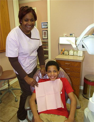 Image: Gentle care — Italy Dental cares for their adult patients with the same gentle approach used with the children as Caleb gets assistance from Caren.