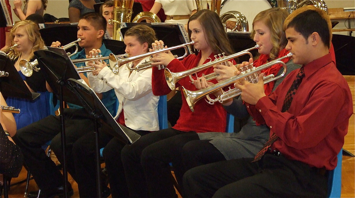 Image: Reid Jacinto, Madison Washington, Amber Hooker, Tara Wallis, Joe Celis and Jennifer McDaniel join in with their Gladiator Regiment Band members to spread Christmas cheer.