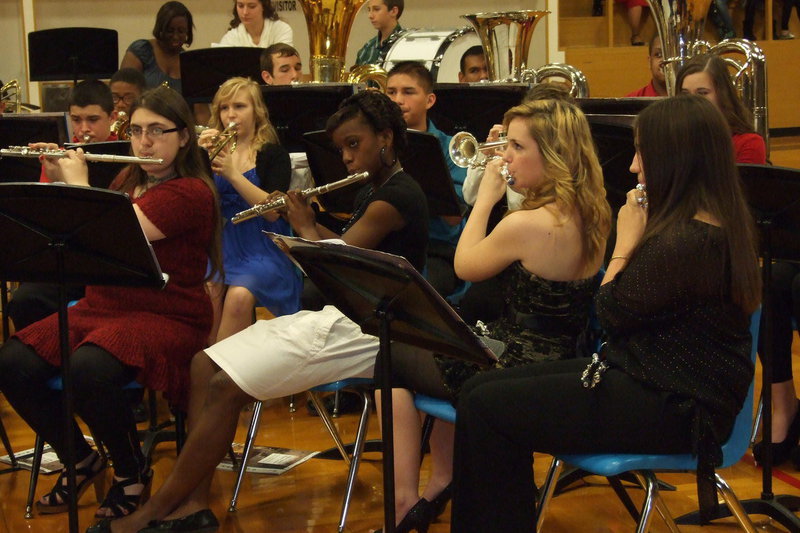 Image: Morgan Junkin, Kortnei Johnson, Sarah Levy and Alexis Sampley play flutes during the Christmas concert.
