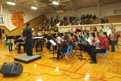 Image: Band director Jesus Perez addresses the band before their holiday performance.