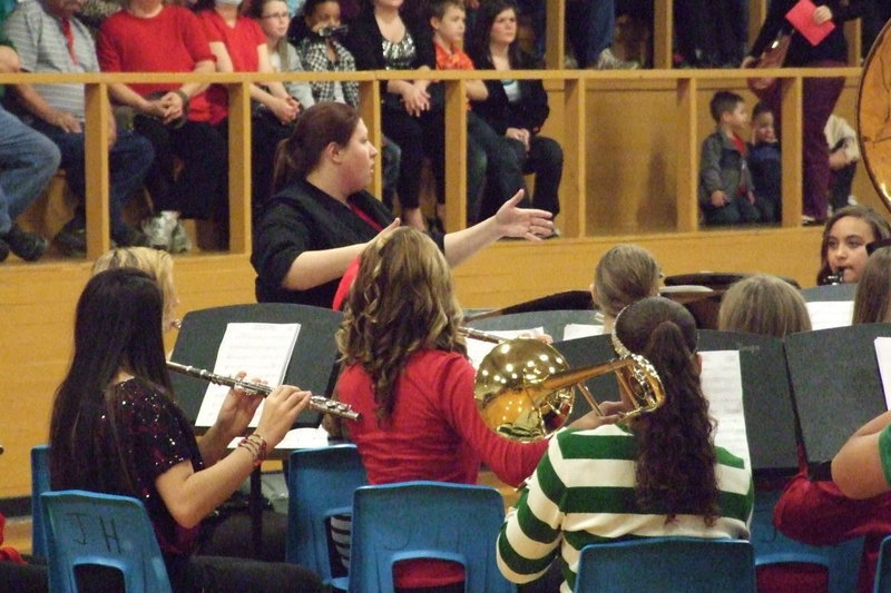 Image: Assistant band director Erica Miller guides the JH Band during a song as the crowd stays rivoted.