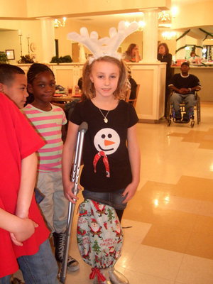 Image: She is decked out in Christmas fun, even her cast is sporting Christmas fun.