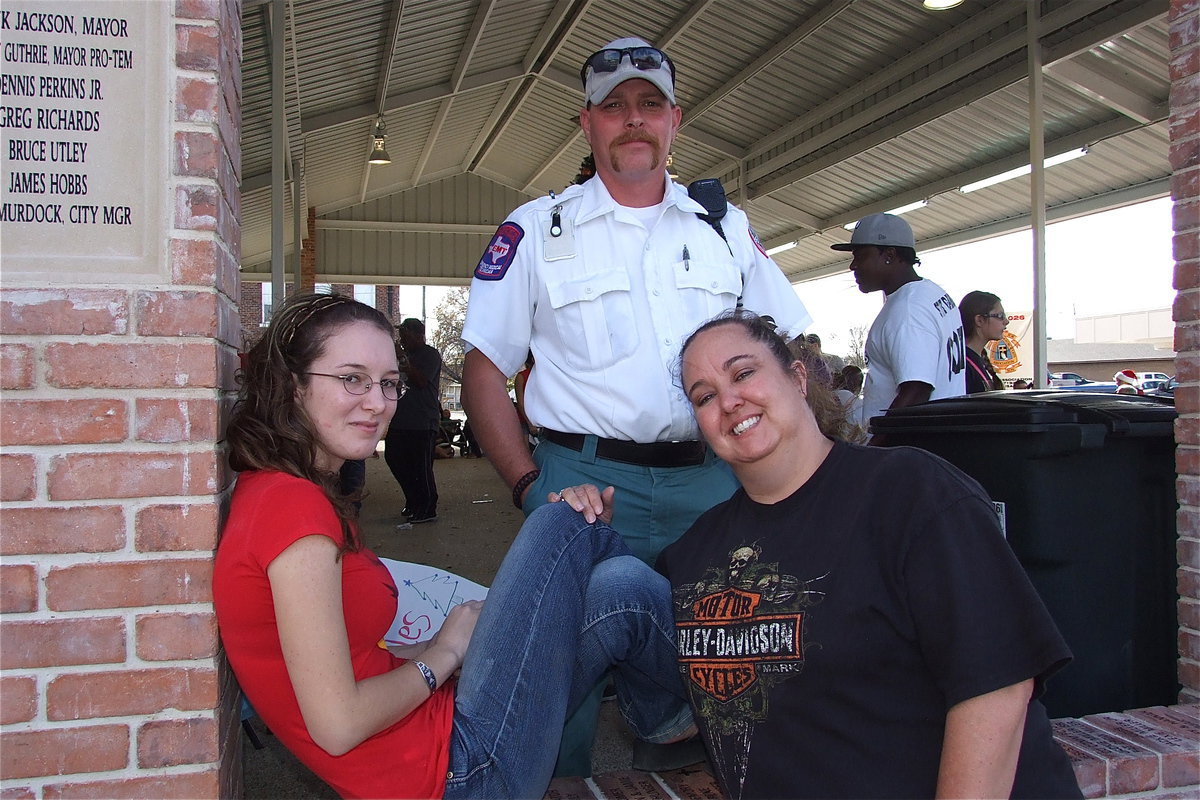 Image: Cheyenne Frank and her parents Wendy and Andy Frank relax in one of the open arched windows located along the front of the pavilion.