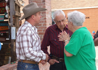 Image: Jon Mathers visits with Joe and Pat Bradley outside the pavilion entrance.