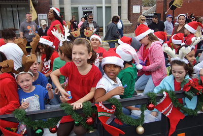 Image: The Stafford Choir tosses candy from their float while passing in front of Italy City Hall.
